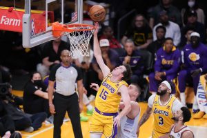 May 22, 2023; Los Angeles, California, USA; Los Angeles Lakers guard Austin Reaves (15) shoots the ball against Denver Nuggets center Nikola Jokic (15) during the second quarter in game four of the Western Conference Finals for the 2023 NBA playoffs at Crypto.com Arena. Mandatory Credit: Kirby Lee-USA TODAY Sports