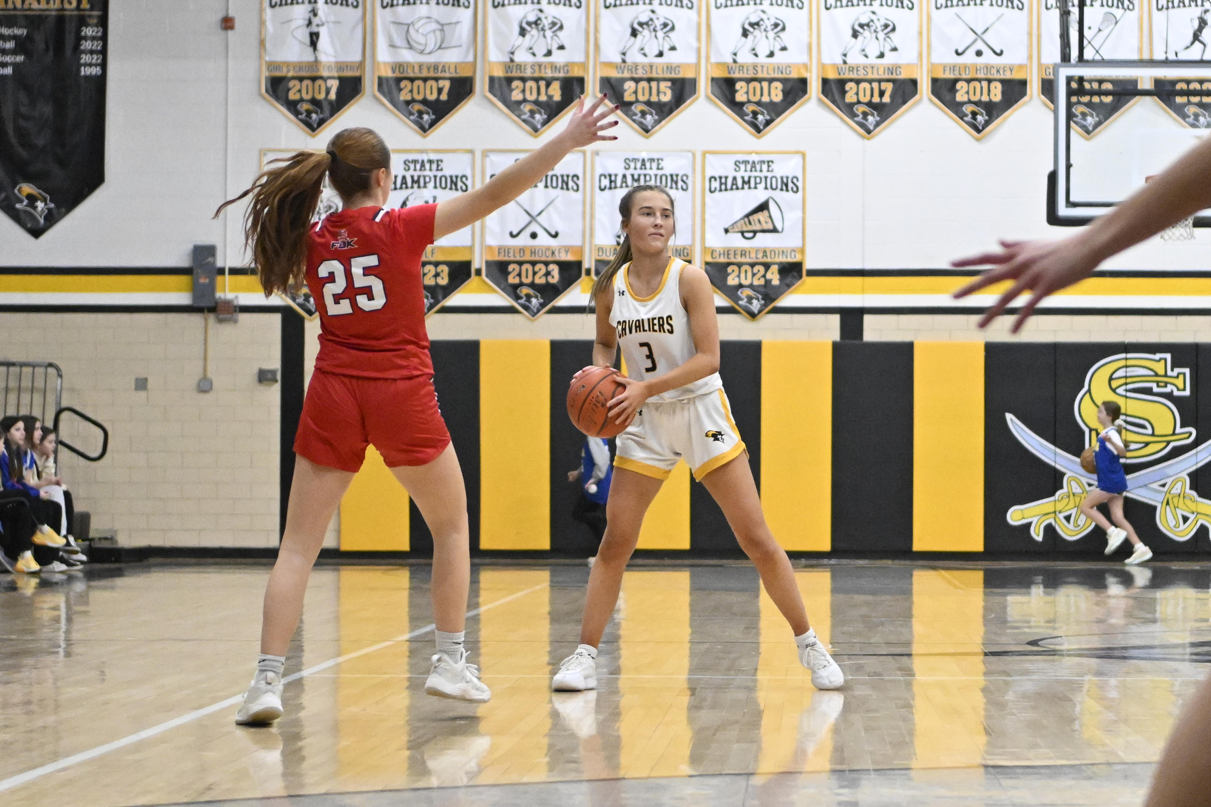 Kendall Curtin looks to pass the ball as Francis Scott...