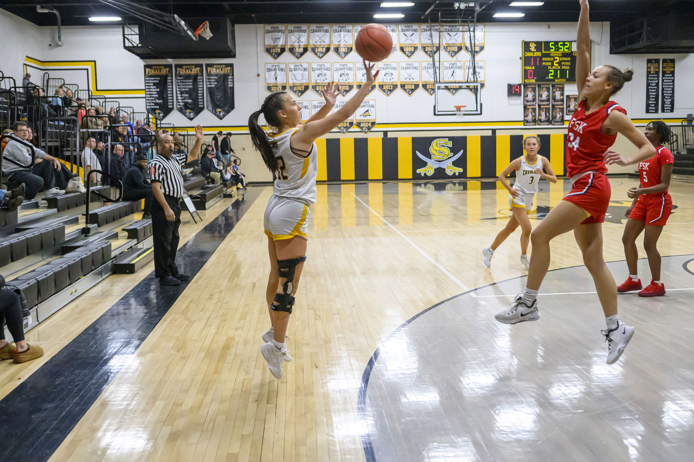 Caden Curtin shoots a three-pointer as Francis Scott Key's Kensi...