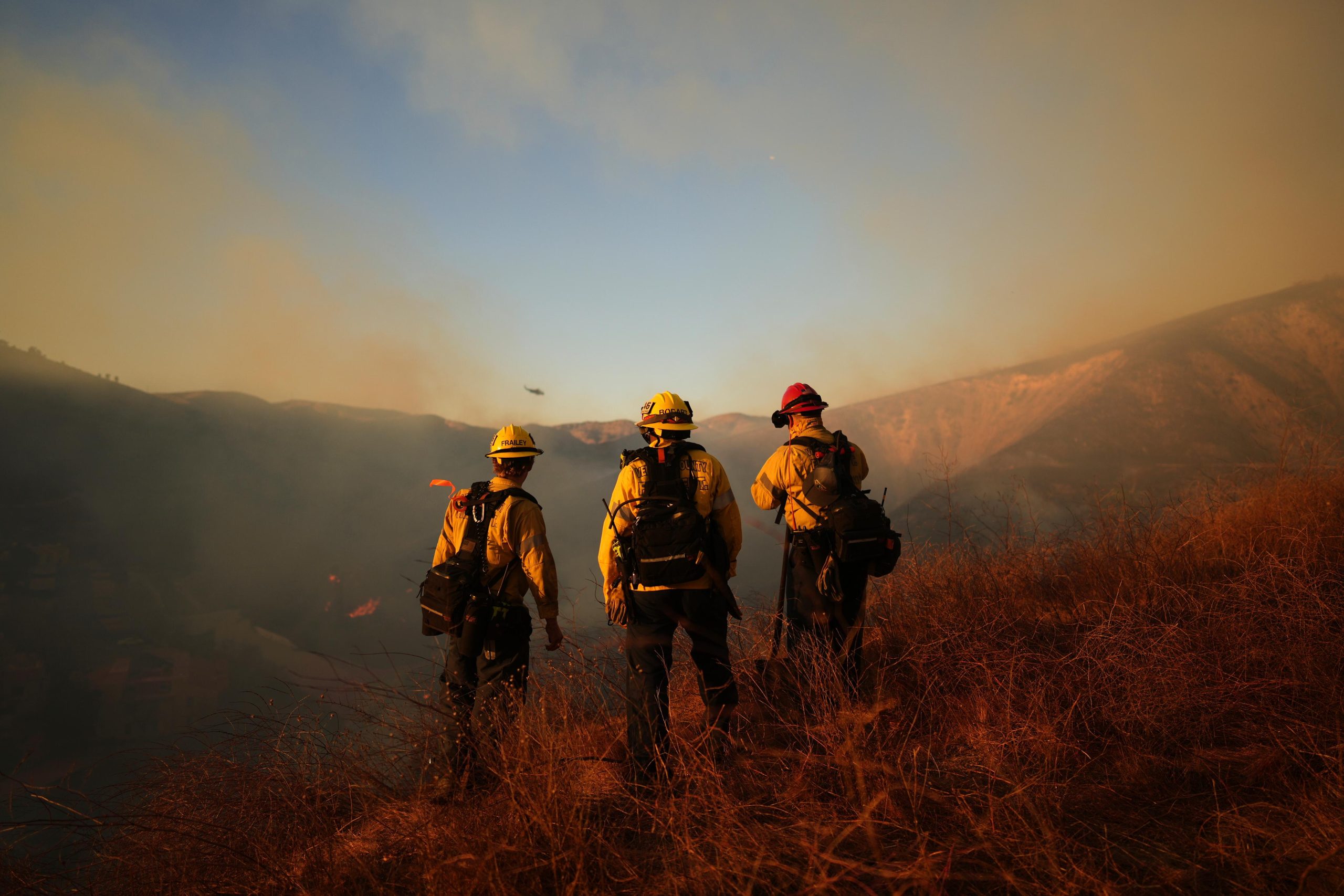 Firefighters look out over the Kenneth Fire, Thursday, Jan. 9,...