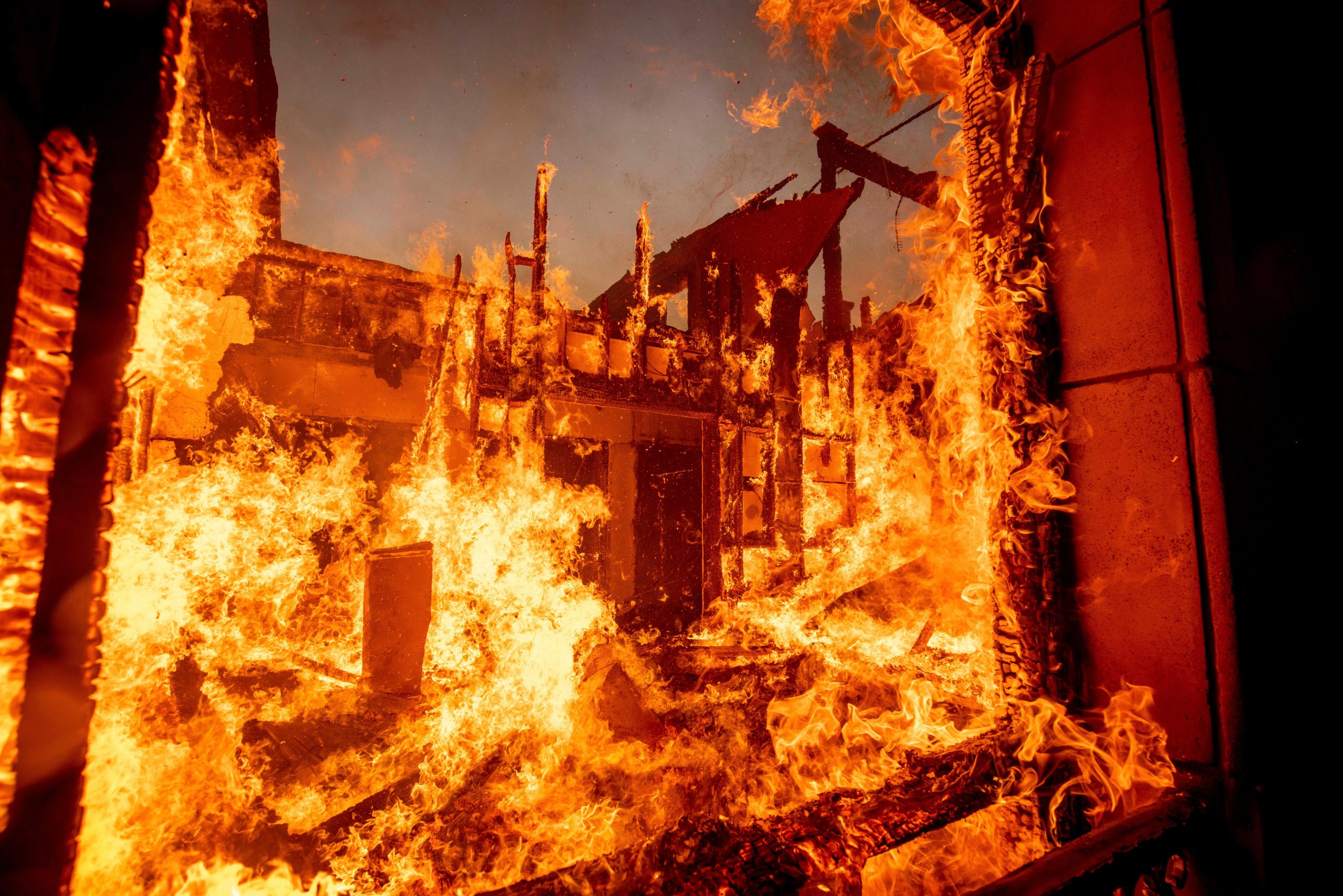 The Palisades Fire burns a residence in the Pacific Palisades...