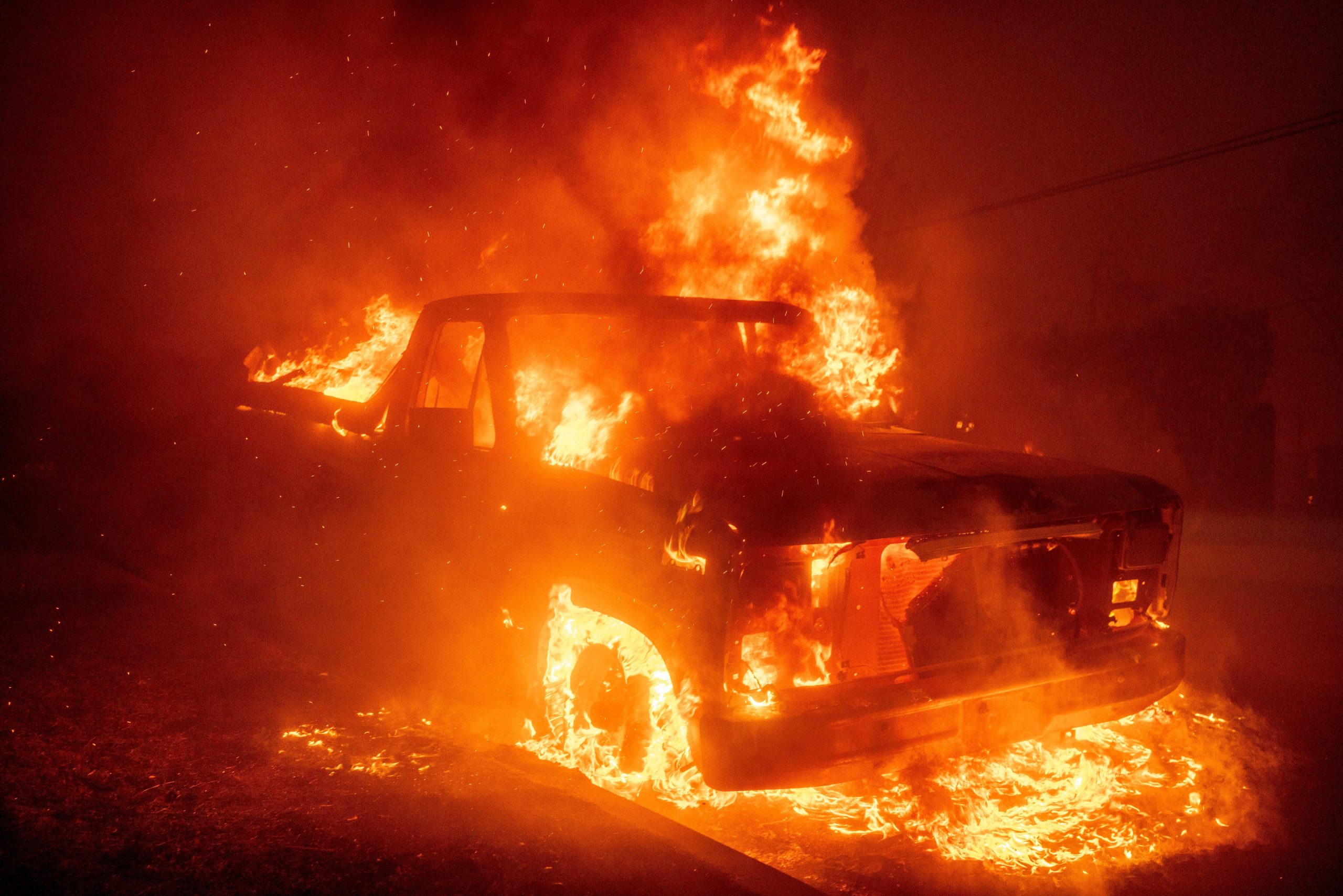 The Eaton Fire burns a vehicle Wednesday, Jan. 8, 2025,...