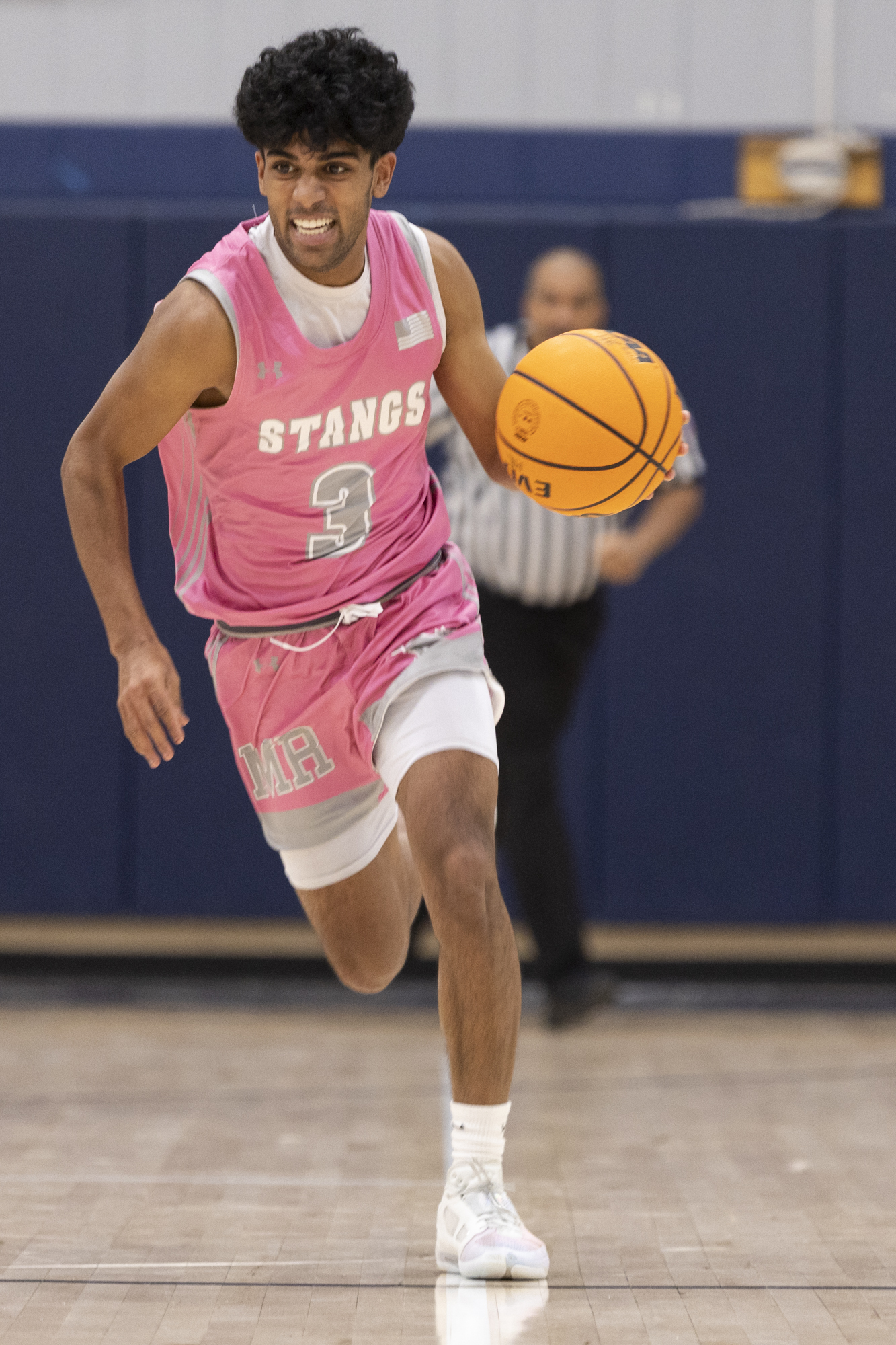 Rahul Jampan charges down the court during the game between...