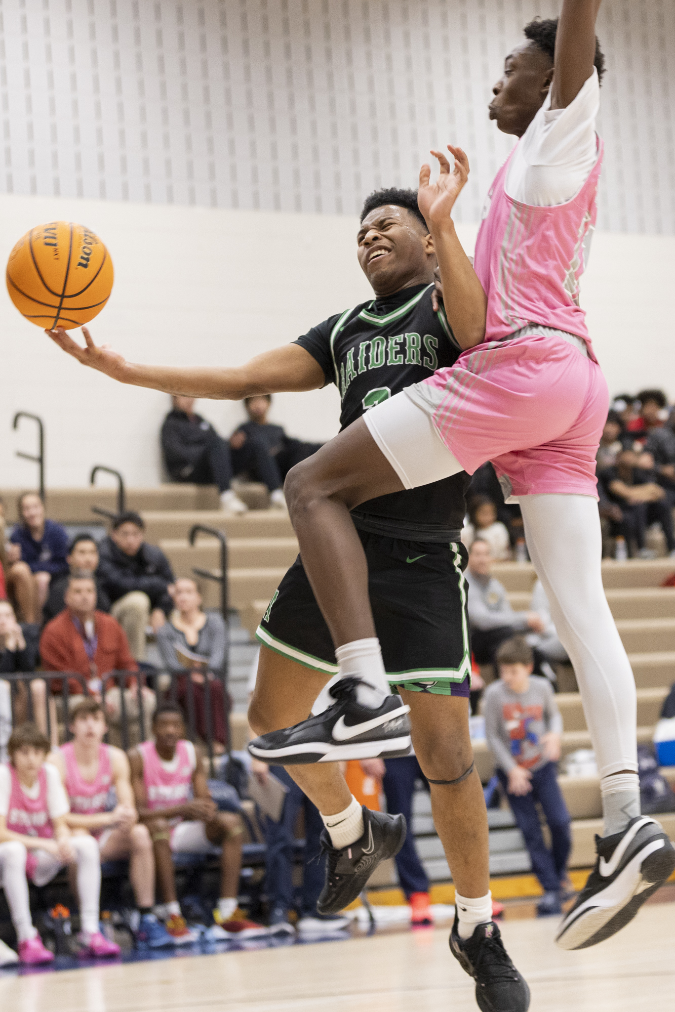 Cam Lyons is fouled by Israel Odekoya while going up...