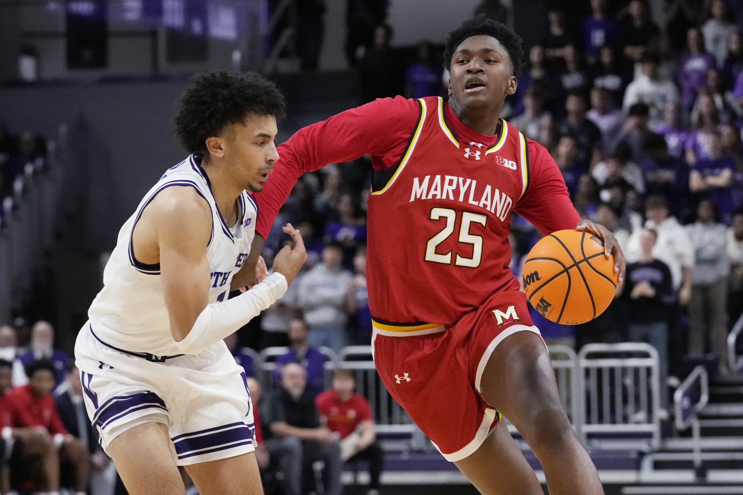 Maryland center Derik Queen, right, drives as Northwestern guard Jalen...