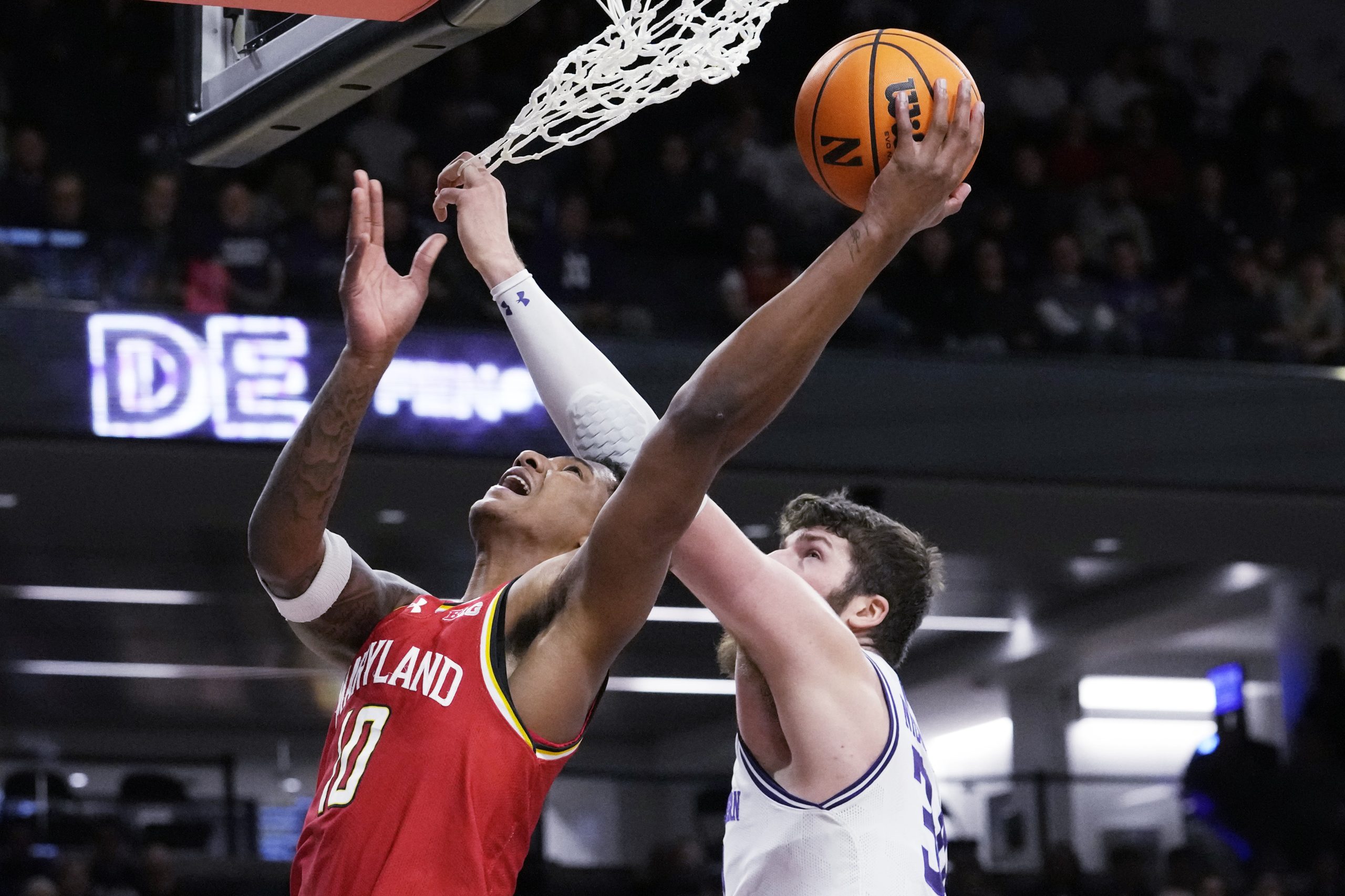 Maryland forward Julian Reese, left, shoots against Northwestern center Matthew...