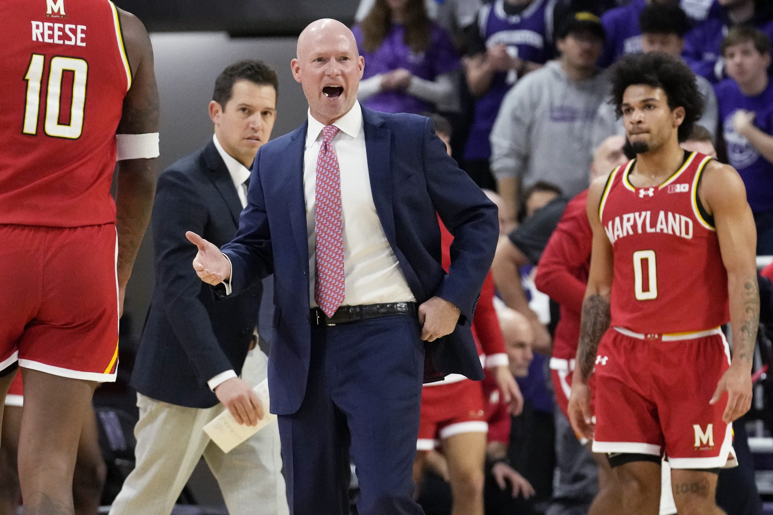 Maryland head coach Kevin Willard, center, reacts to a call...