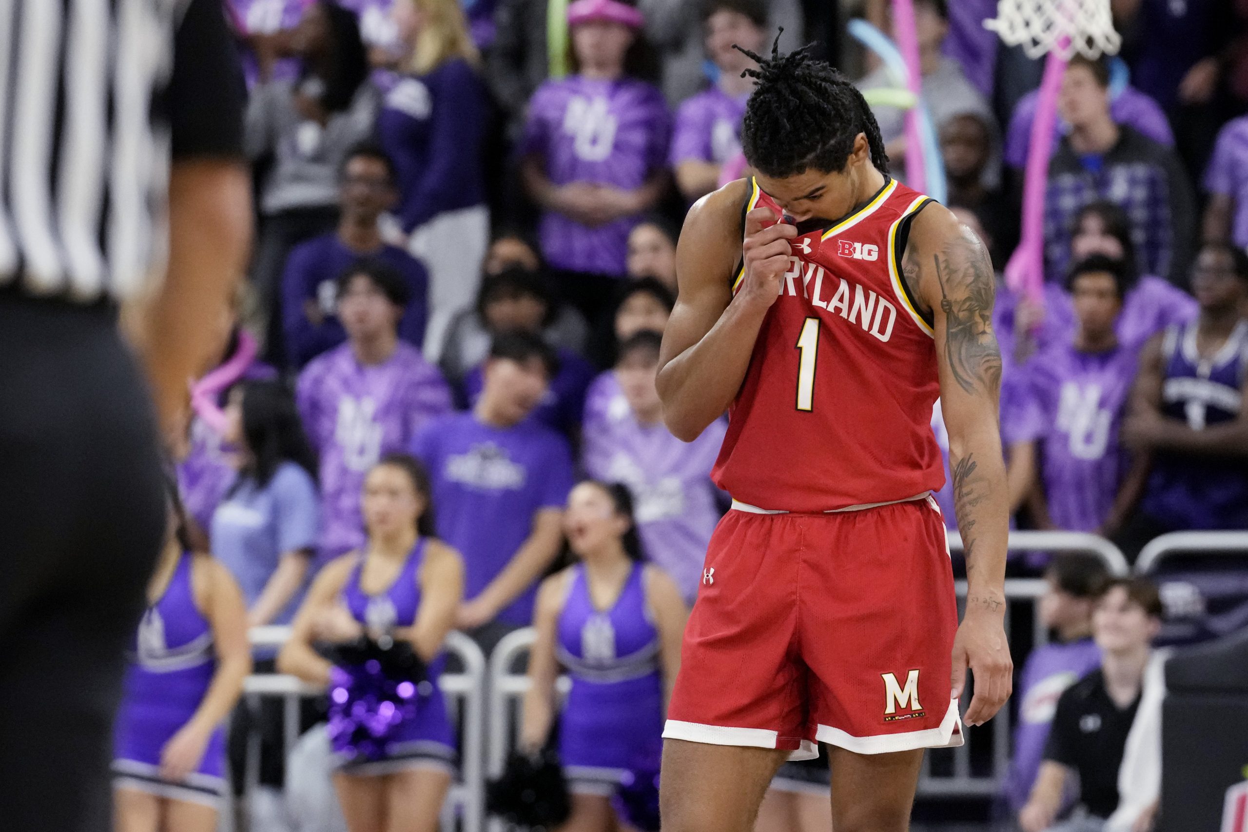 Maryland guard Rodney Rice wipes his face after he was...