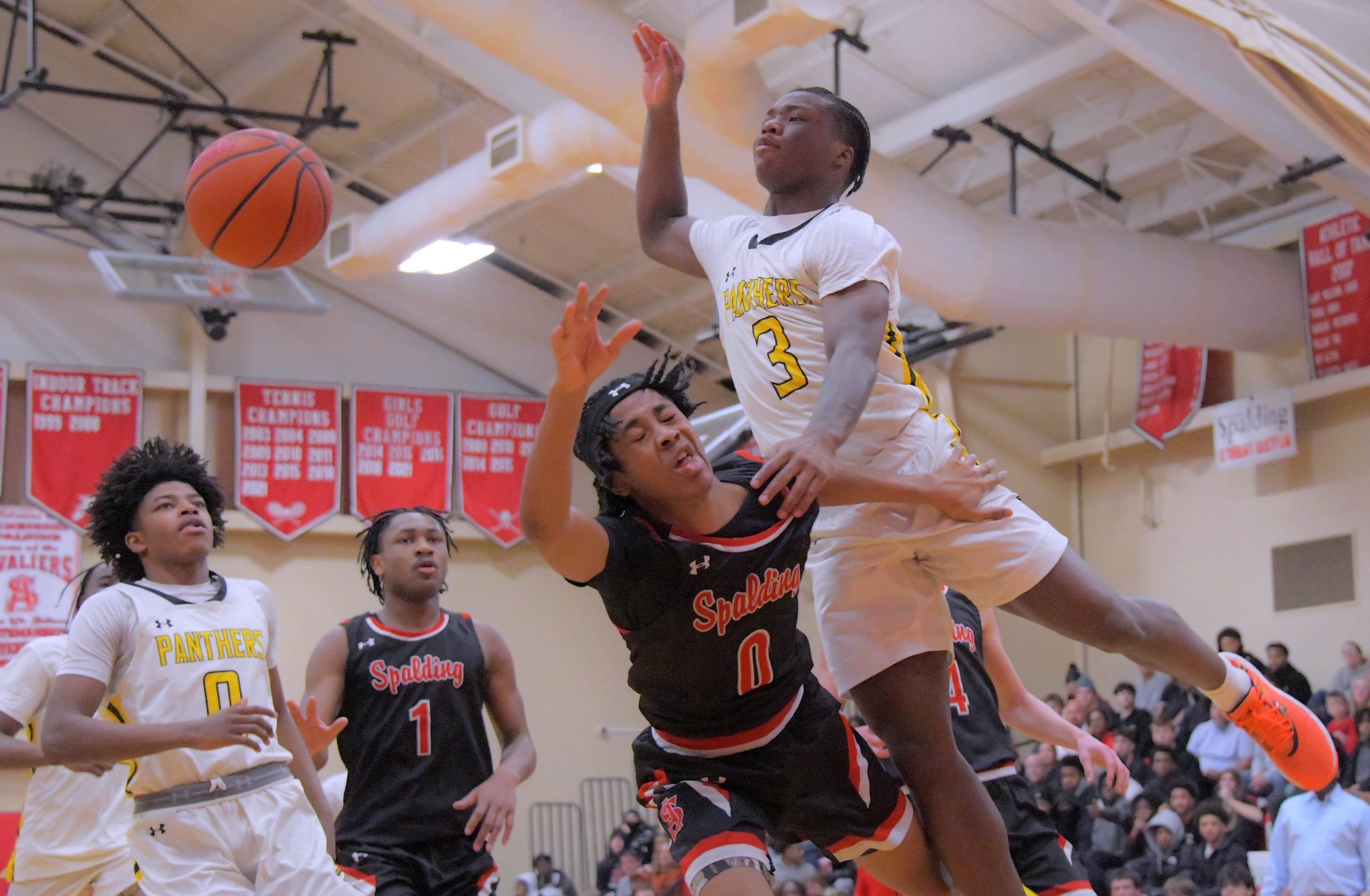 Saint Frances Panthers point guard Kamauri Lawson fouls Archbishop Spalding...