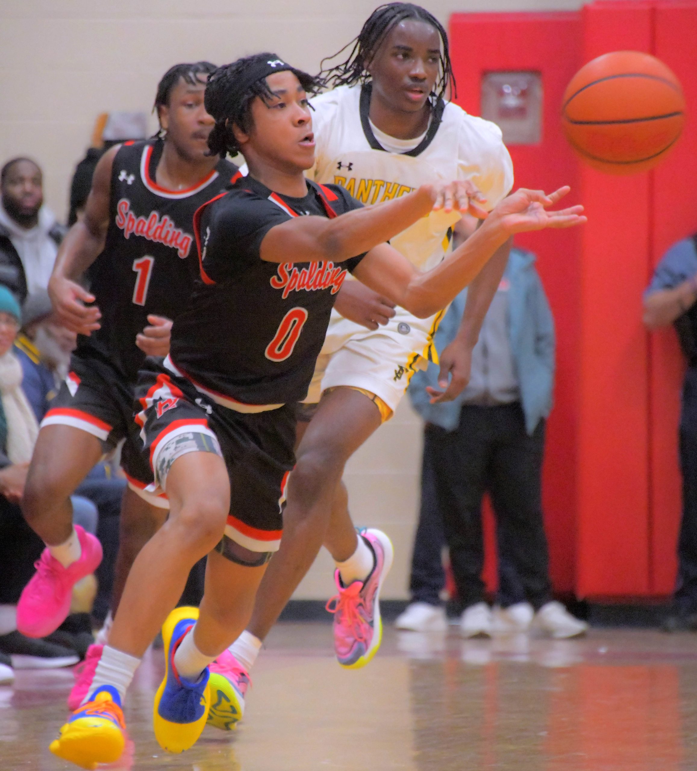 Archbishop Spalding Cavaliers guard Kameron Carter feeds forward Braxton Bogard...