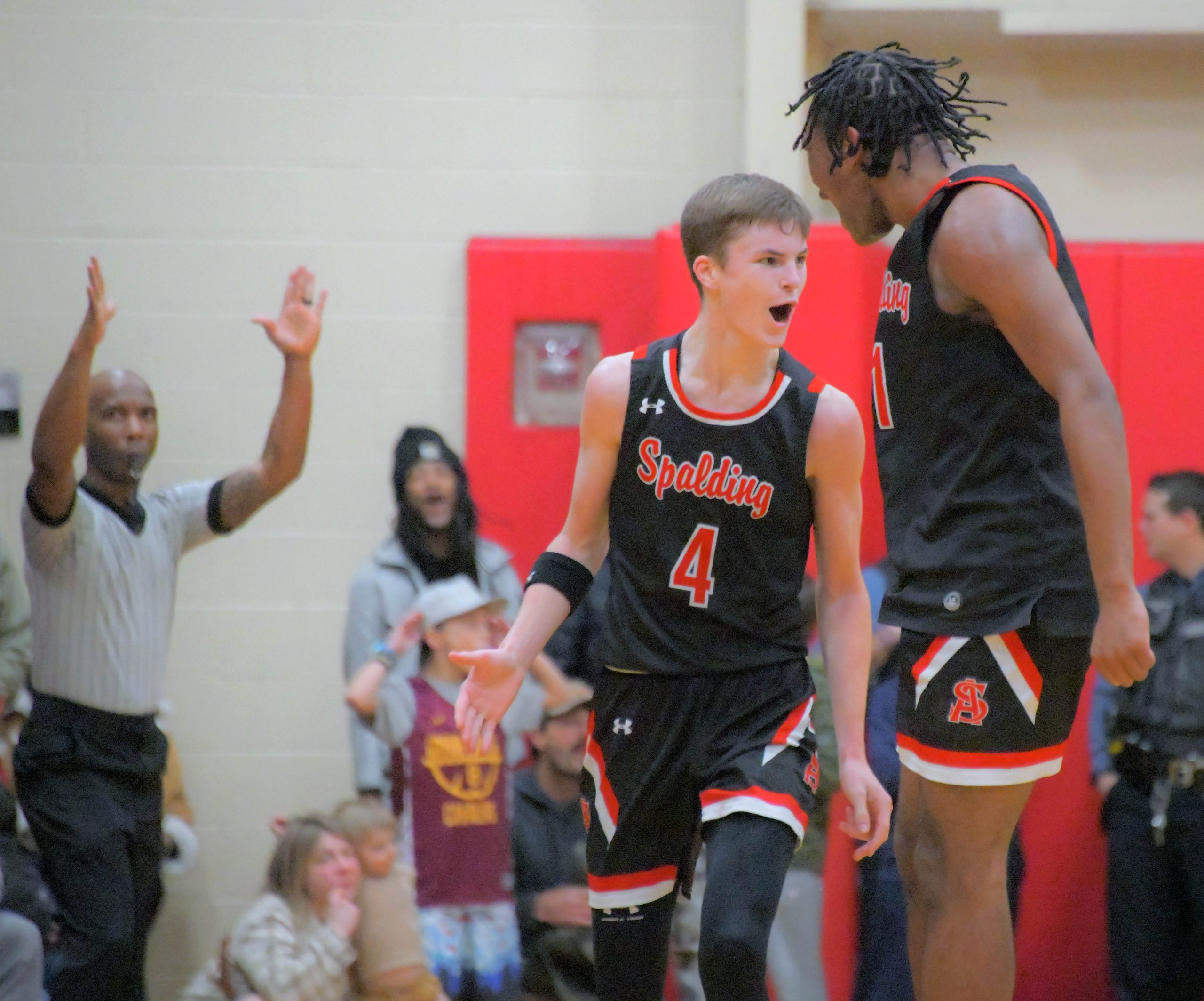 Spalding Cavaliers guard Colt Busse, left, reacts after nailing a...