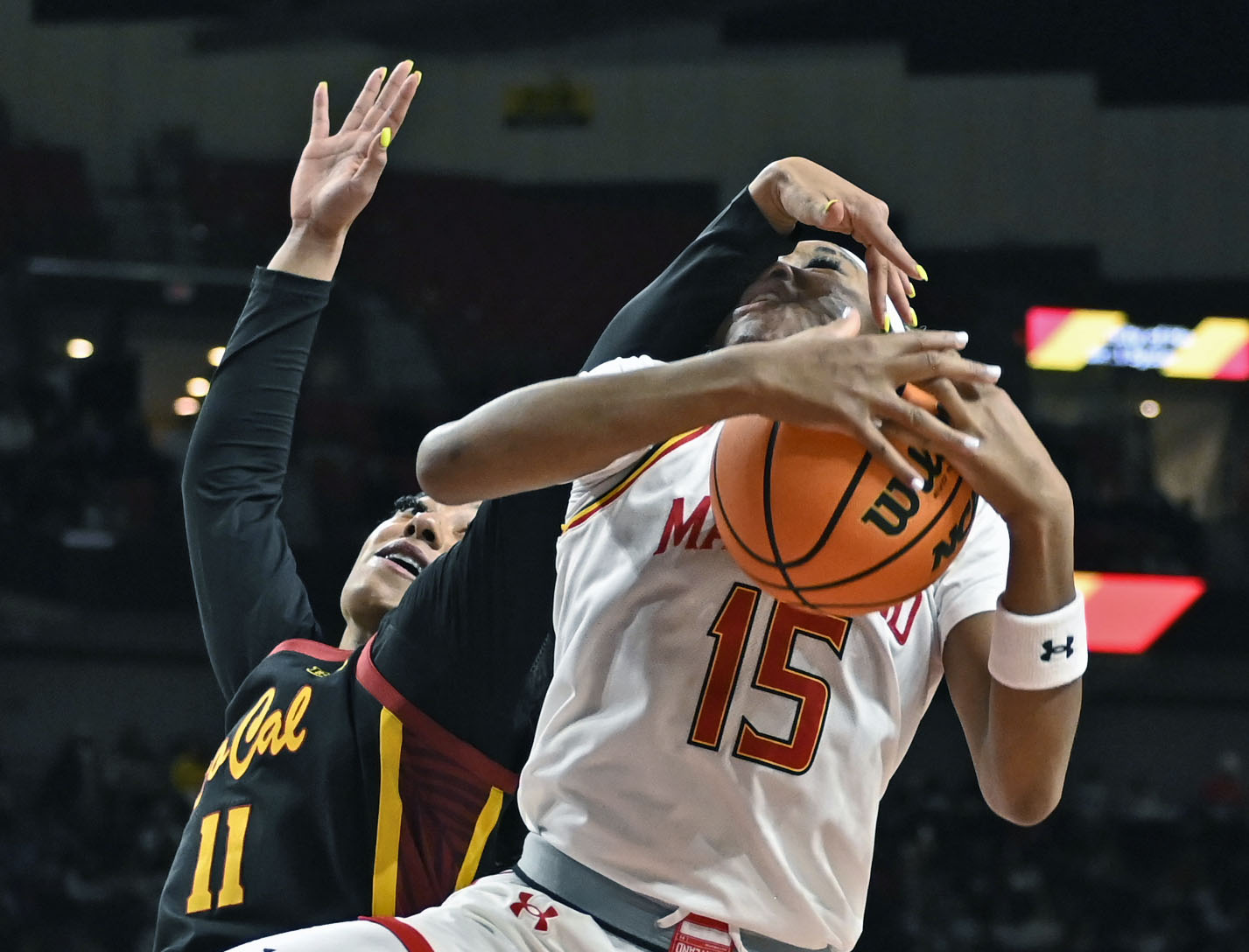 Maryland’s Christina Dalce, right, runs into a block by USC’s...