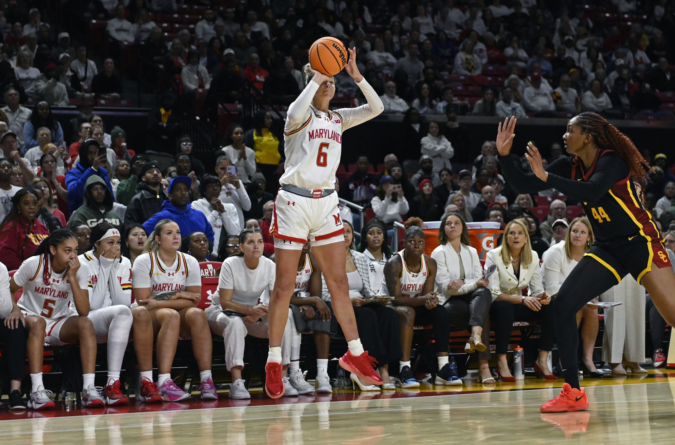 Maryland’s Saylor Poffenbarger, center, fails to convert a three-point shot...