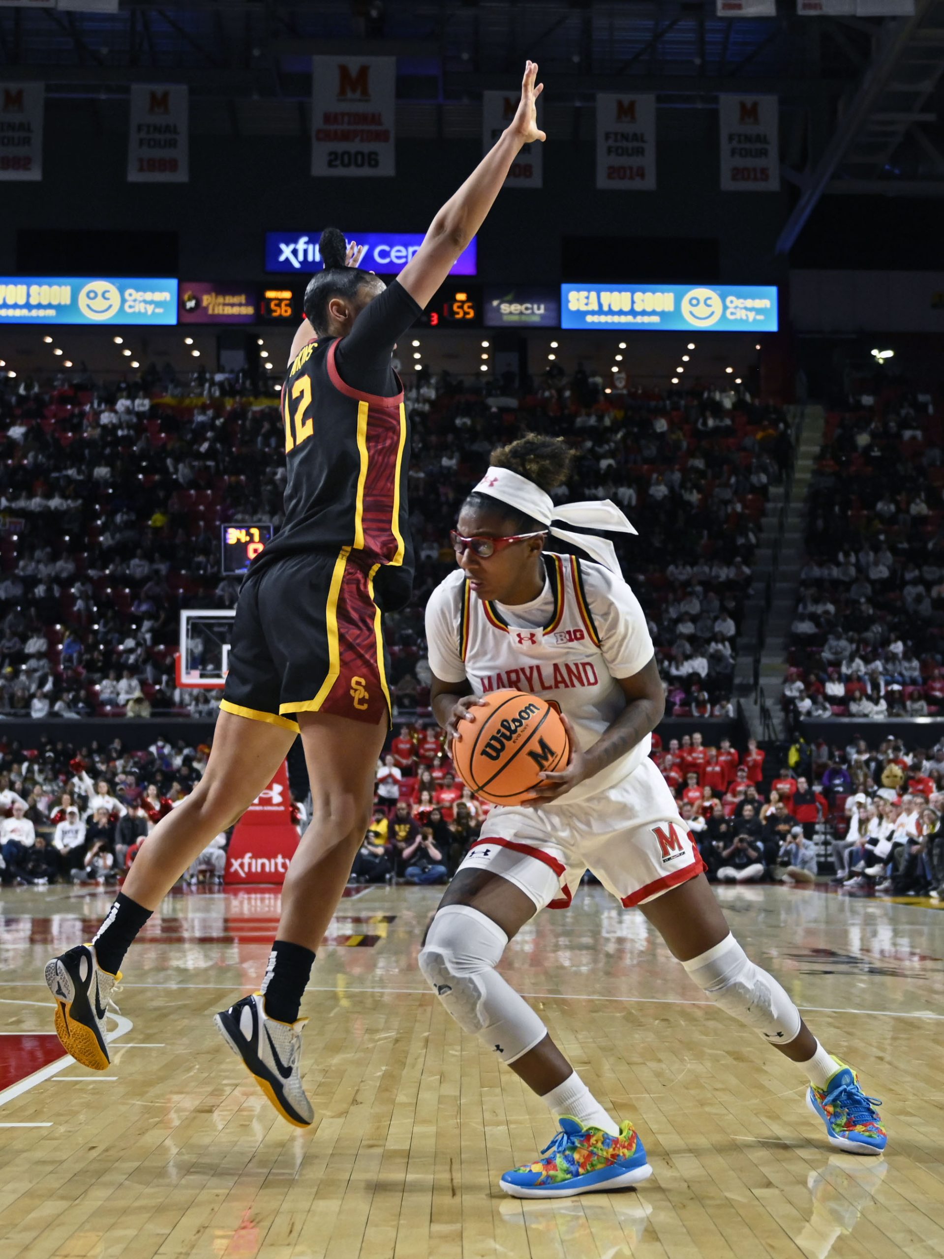 Maryland’s Shyanne Sellers, right, pumps fake USC’s JuJu Watkins to...