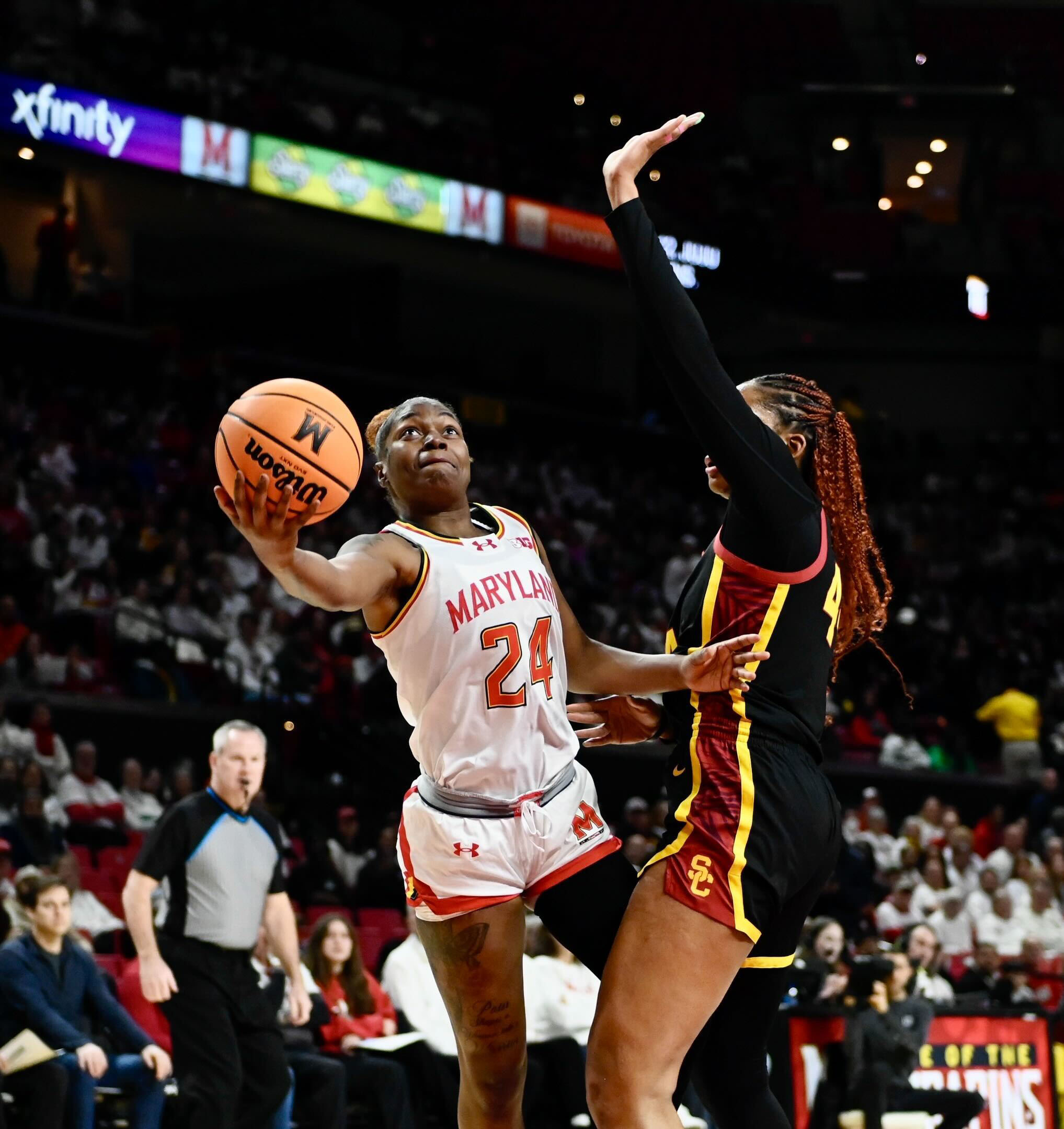 Maryland’s Bri McDaniel, left is fouled by USC’s Kiki Iriafen...