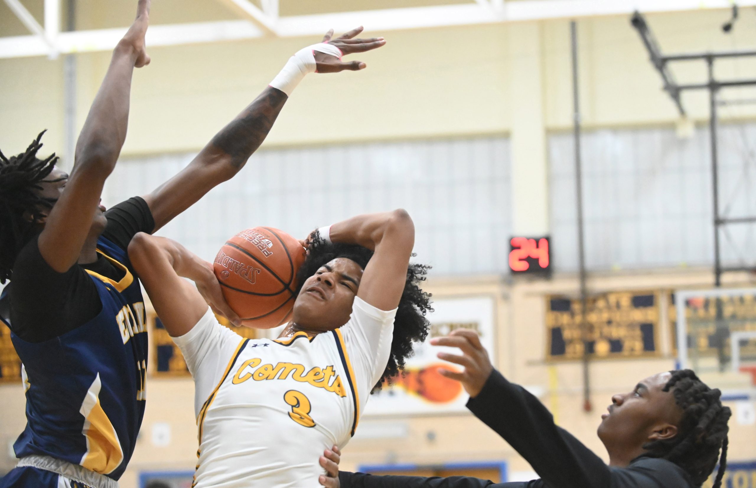 Catonsville's Gavin Edwards has difficutly getting a shot off with...