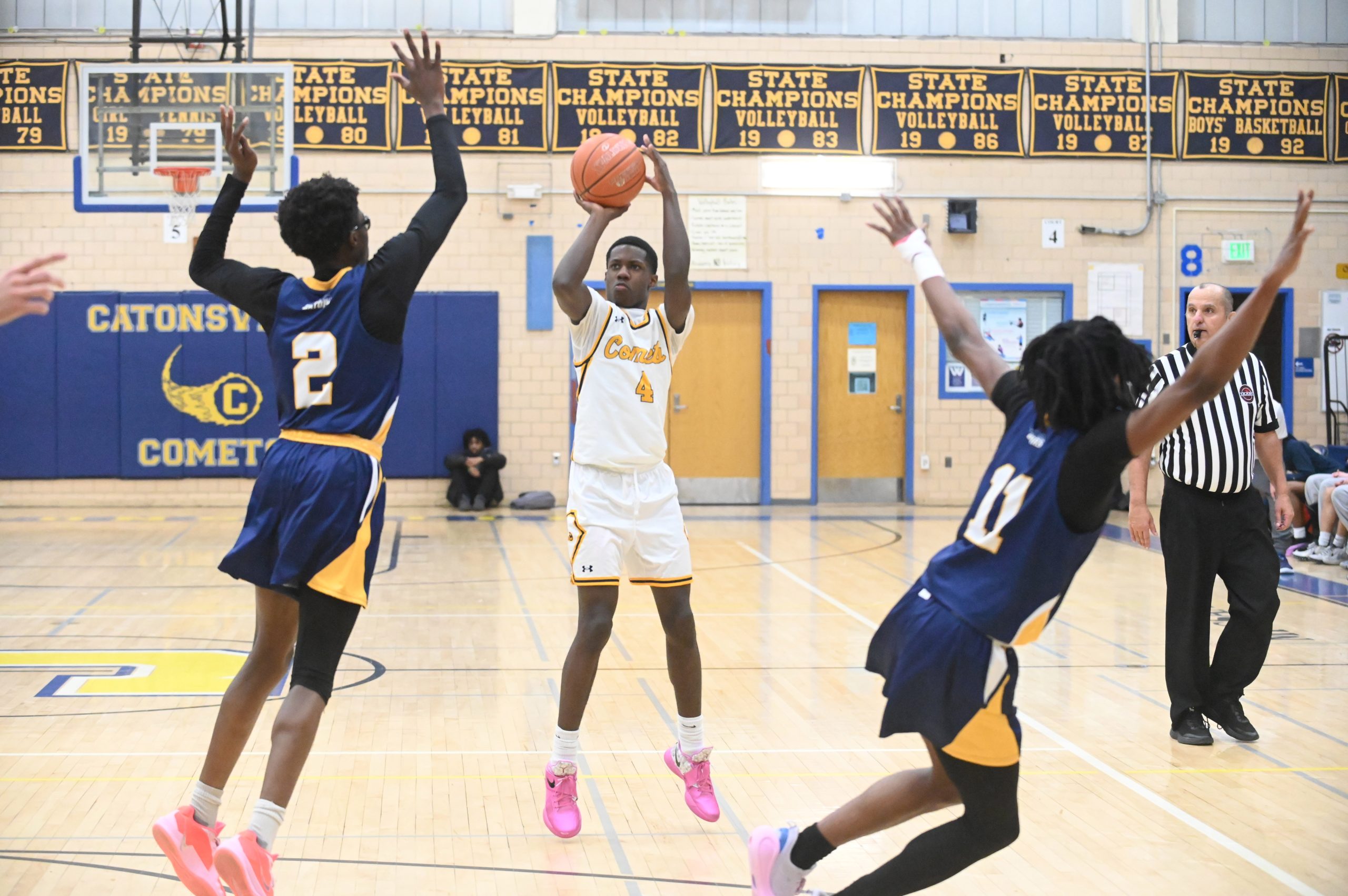 Catonsville's Joele Johnson takes aim at a 3-point shot over...