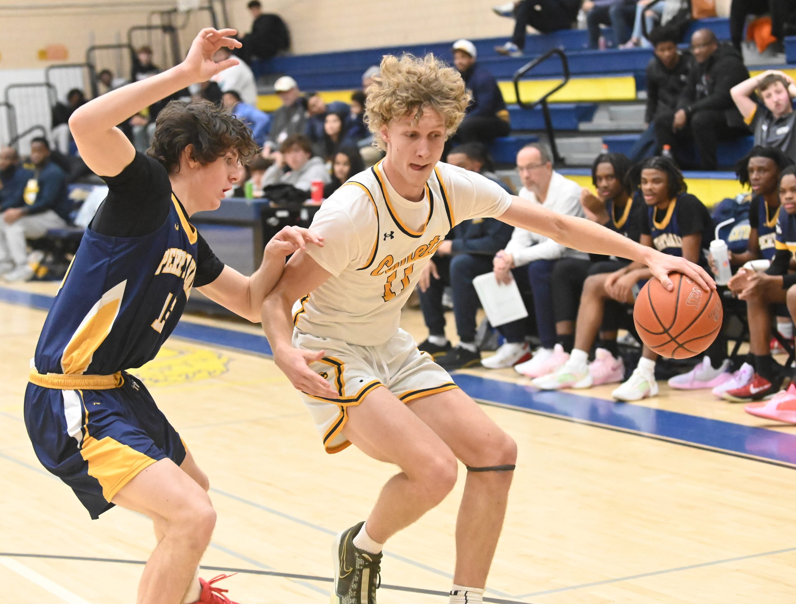 Catonsville's Nate Holub-Smith, right, tries to elude pressure from Perry...