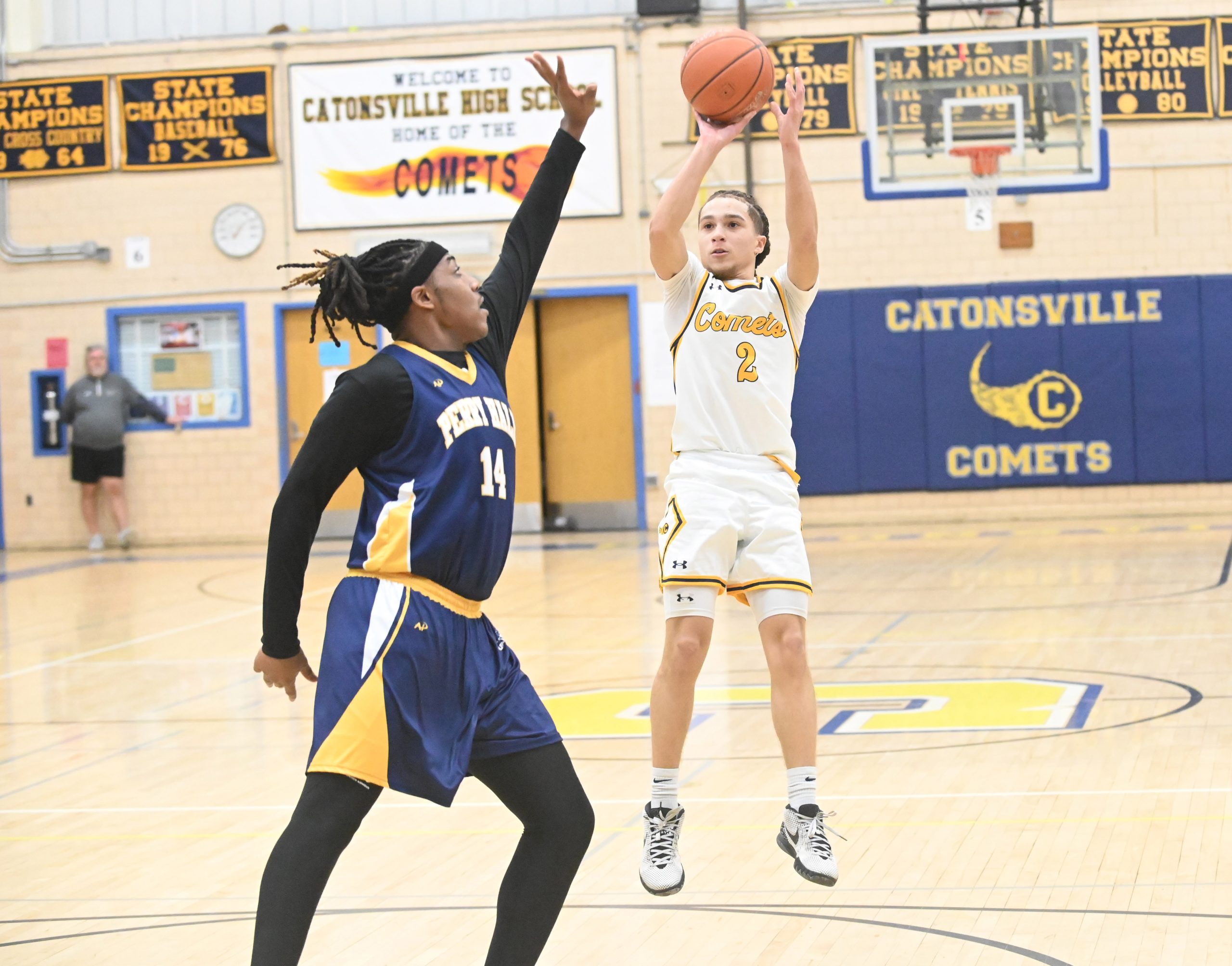 Catonsville's Gavin Jones puts up a shot over Perry Hall's...