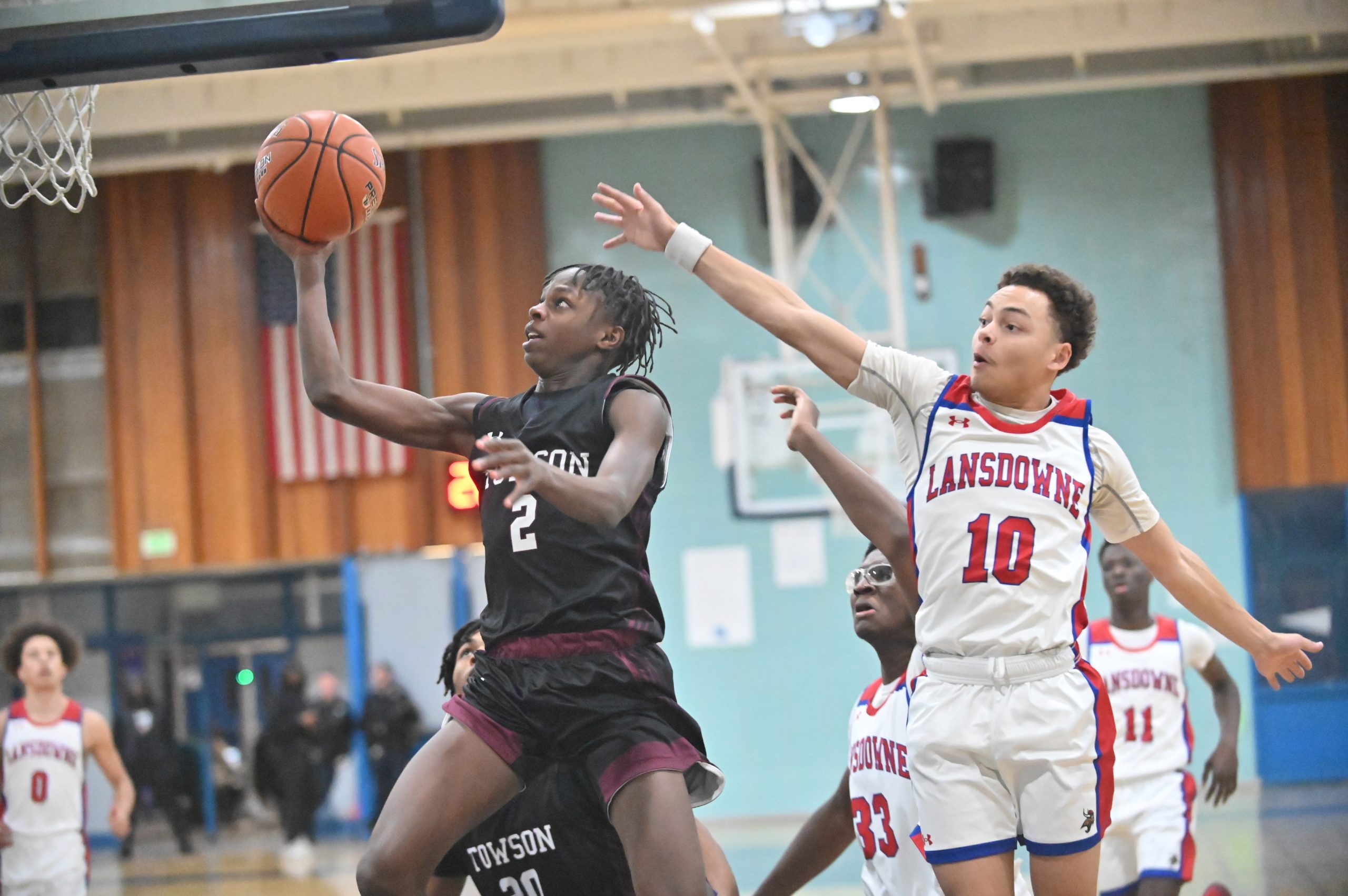 Towson's Seven Wheeler gets past Lansdowne's Jordon West as he...