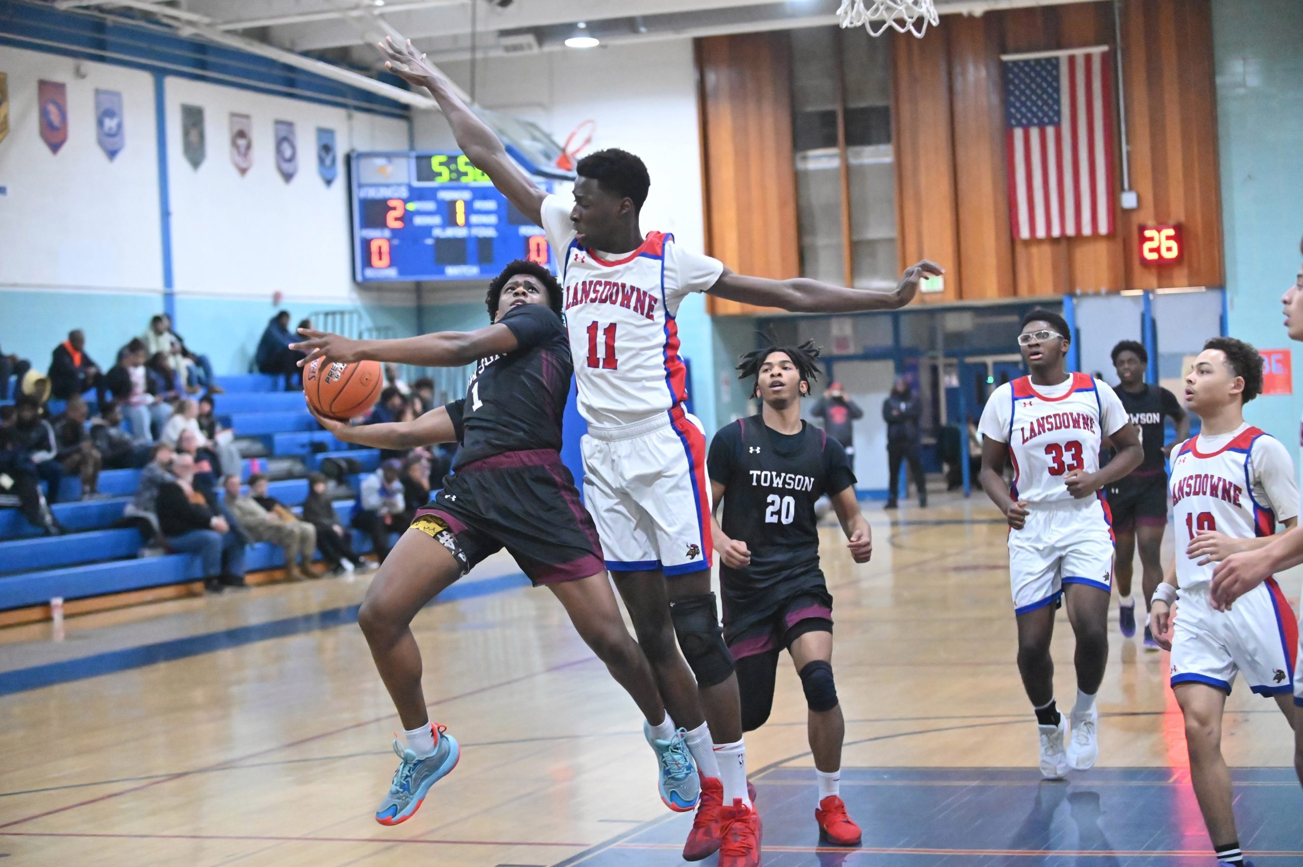 Towson's Jeremiah Harris has difficulty releasing a shot with Lansdowne's...