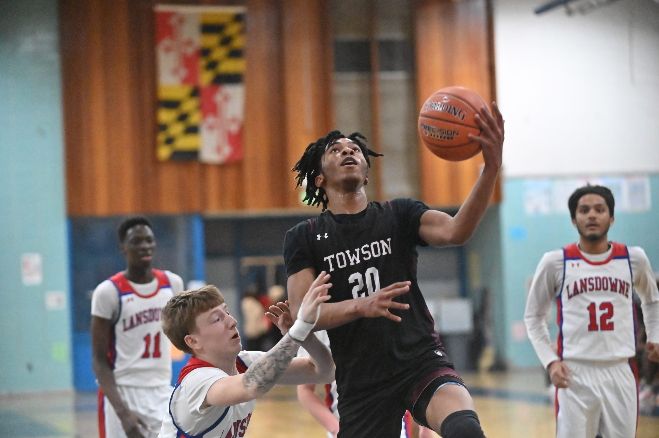 Towson's Gregory Skinner gets past Lansdowne's Ryan Kehoe as he...