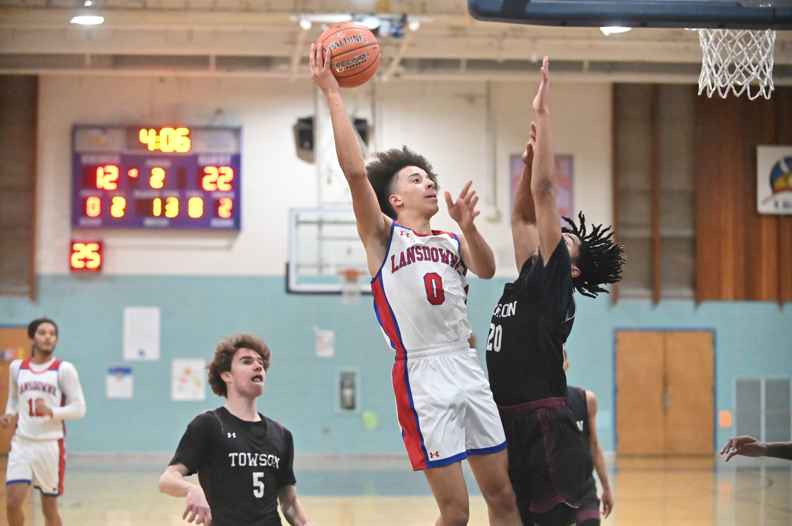 Lansdowne's Trevor Howard releases a shot while pressured by Towson's...