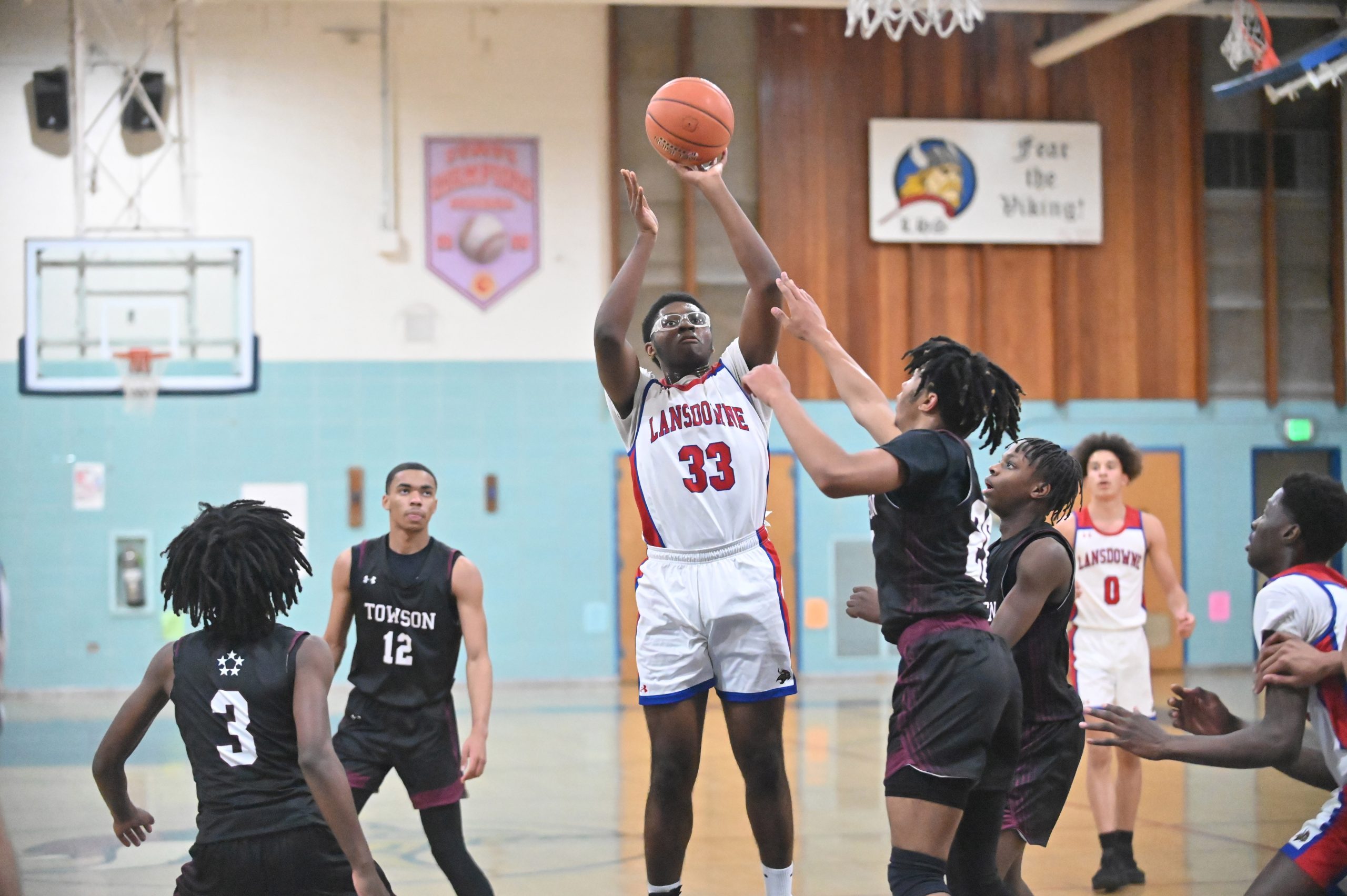 Lansdowne's Josh Rogers releases a shot over Towson defenders during...