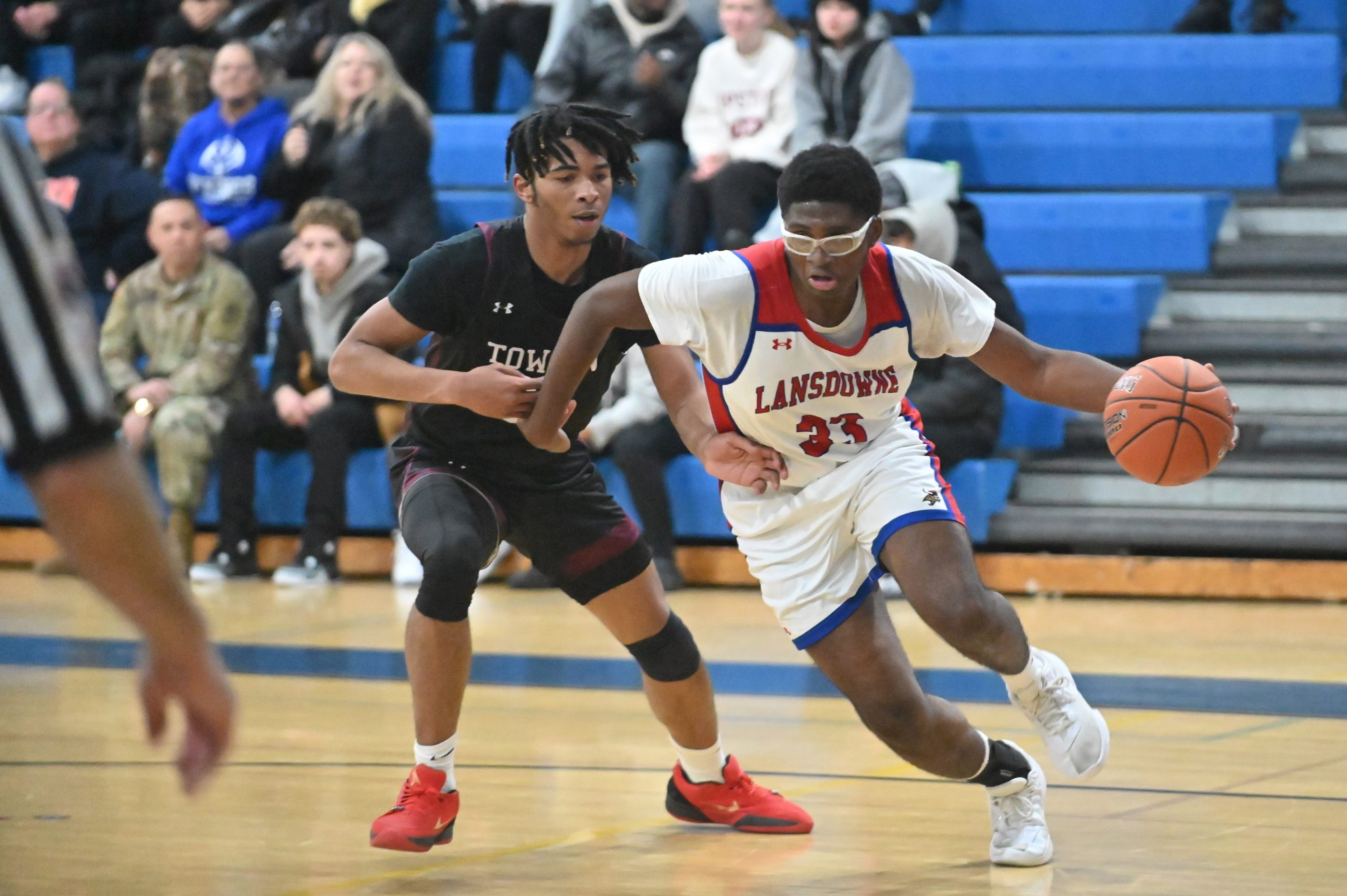 Lansdowne's Josh Rogers tries to get past Towson's Gregory Skinner...