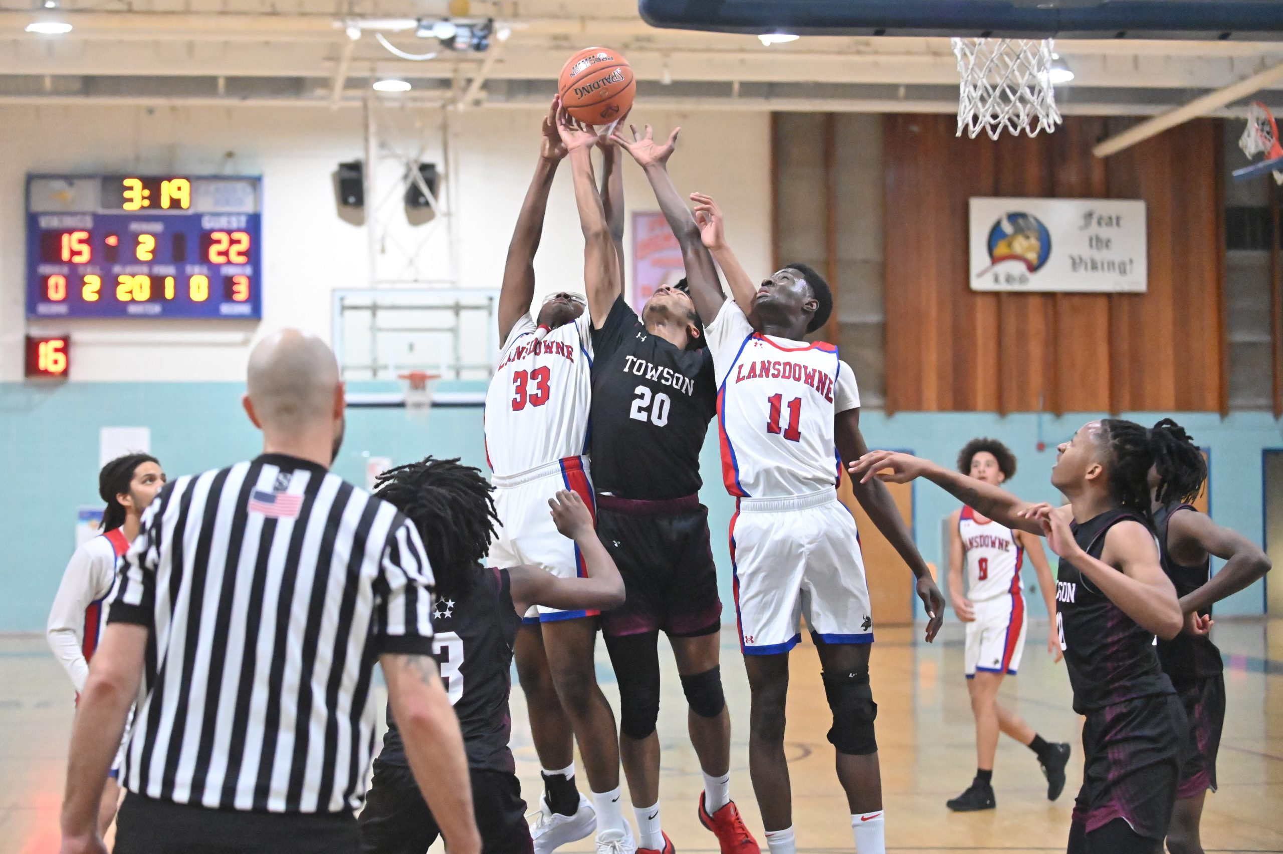 Lansdowne and Towson players compete for a rebound during a...