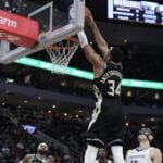 Feb 2, 2025; Milwaukee, Wisconsin, USA; Milwaukee Bucks forward Giannis Antetokounmpo (34) dunks the ball against Memphis Grizzlies center Zach Edey (14) in the first half at Fiserv Forum. Mandatory Credit: Michael McLoone-Imagn Images